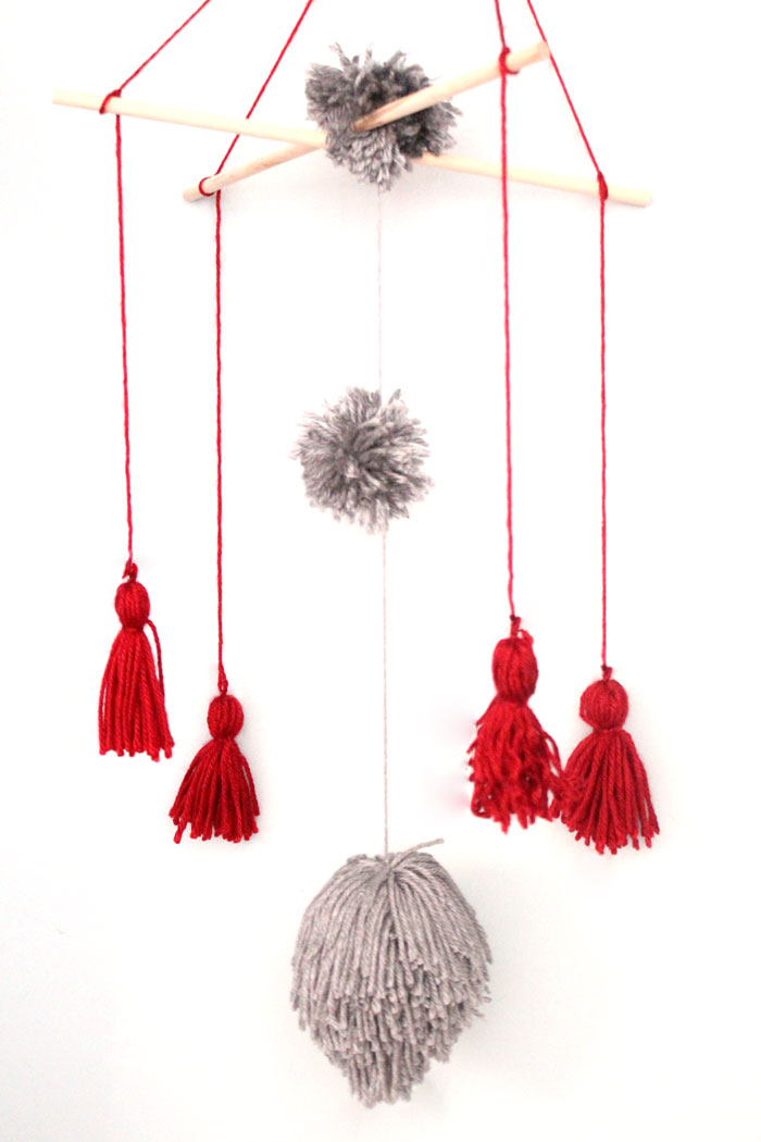 I love this precious tassel and pom pom baby mobile for my baby's nursery! Plus, this cheap and frugal nursery update with a Mickey Mouse theme is awesome!