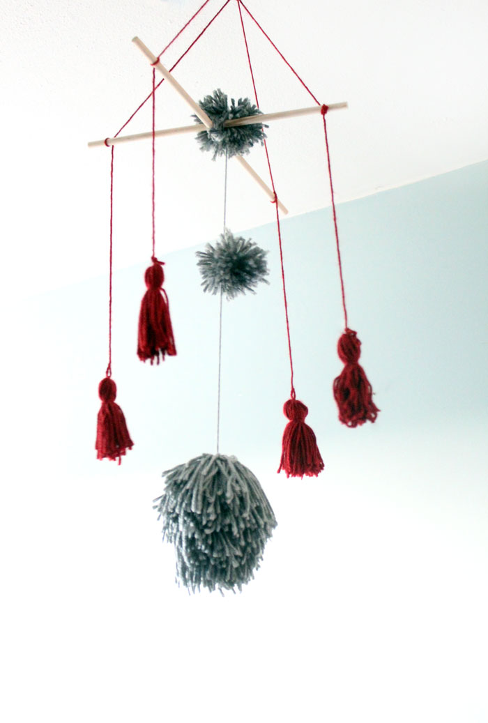 I love this precious tassel and pom pom baby mobile for my baby's nursery! Plus, this cheap and frugal nursery update with a Mickey Mouse theme is awesome!