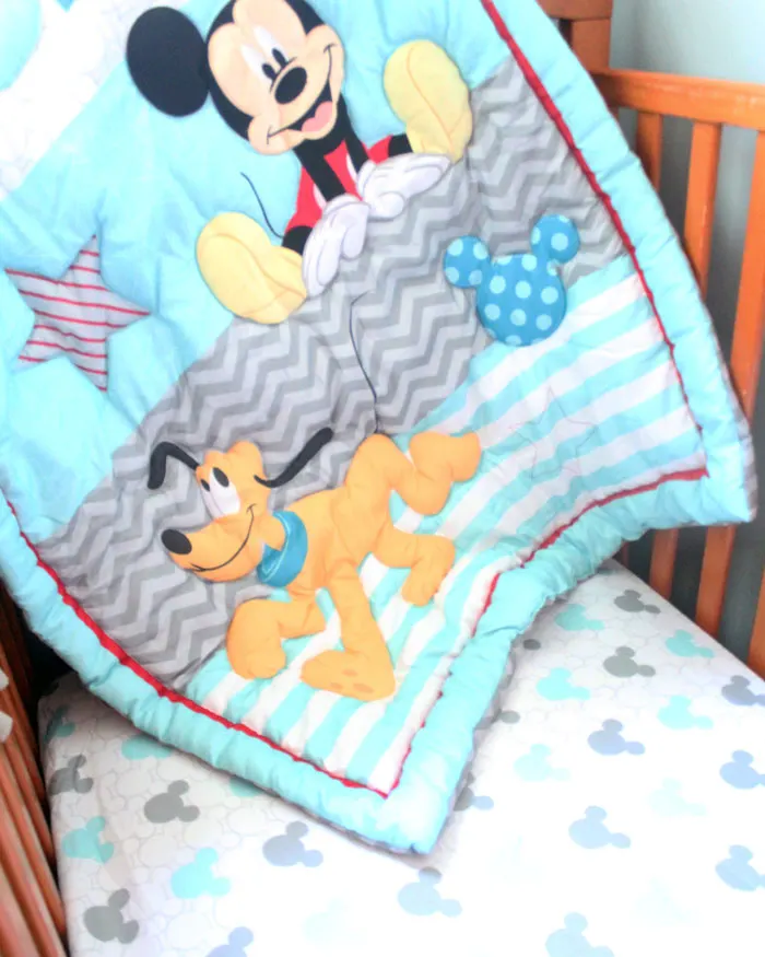 I love this precious tassel and pom pom baby mobile for my baby's nursery! Plus, this cheap and frugal nursery update with a Mickey Mouse theme is awesome!
