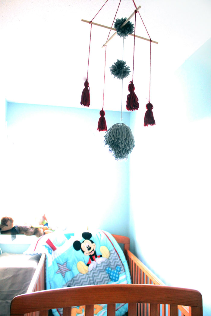 I love this precious tassel and pom pom baby mobile for my baby's nursery! Plus, this cheap and frugal nursery update with a Mickey Mouse theme is awesome!