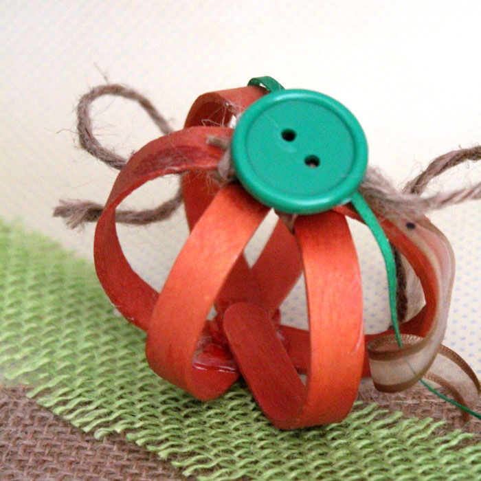 This bent craft stick pumpkin craft is so adorable - you'll want to make a lot for your Autumn or Halloween decor!