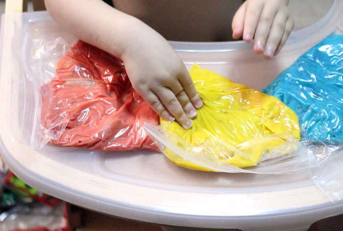 Make this super easy and fun crayon play dough recipe! Your child will love the extra sensory exploration. It's a fun crayon craft to use old crayons, and is an engaging kids activity as well!