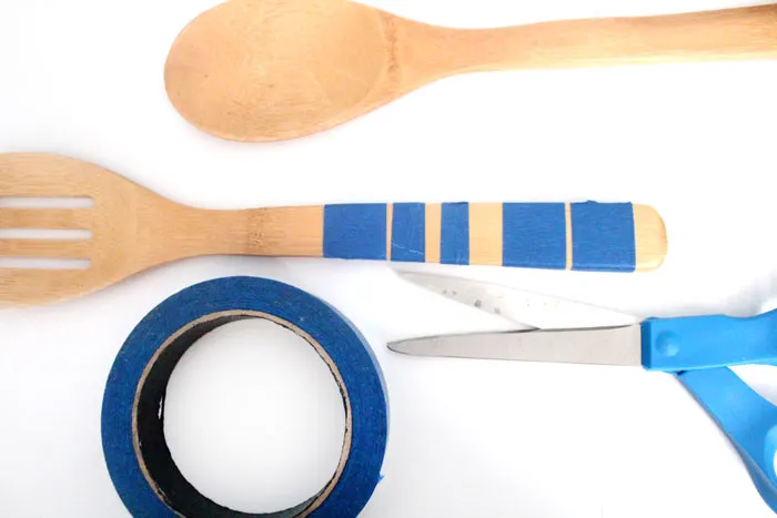 Click to find out the surprising material used to paint these wooden spoons! Painted wooden spoons are a great cheap DIY gift and easy craft. These are striped and durable - perfect for kitchen decor or cooking.