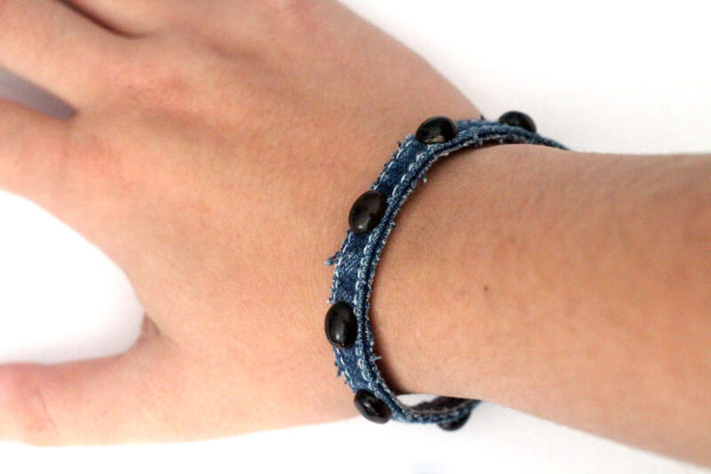 Make this simple no sew DIY denim bracelet by using recycled jeans! This easy jewelry making tutorial is a perfect. cool craft for teens and tweens.