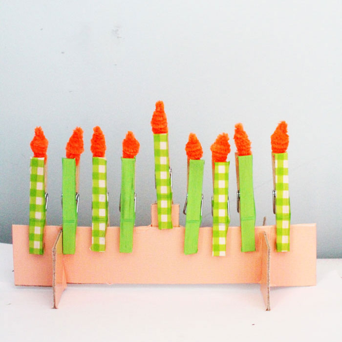 Make this adorable Hanukkah Menorah craft for kids. It's an adorable DIY toy menorah that I made for my toddler to light on Chanukah.