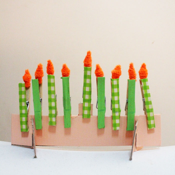 Make this adorable Hanukkah Menorah craft for kids. It's an adorable DIY toy menorah that I made for my toddler to light on Chanukah.