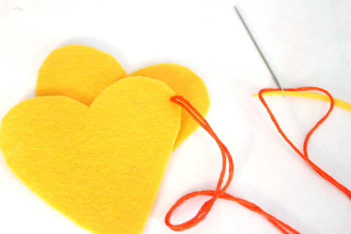 Make this adorable stitched felt craft for Valentine's day or any time of year! It includes a cute favor pouch version, and a plush heart keychain. IT's a great beginner sewing project for kids, teens, and tweens!