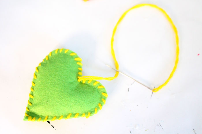 Make this adorable stitched felt craft for Valentine's day or any time of year! It includes a cute favor pouch version, and a plush heart keychain. IT's a great beginner sewing project for kids, teens, and tweens!