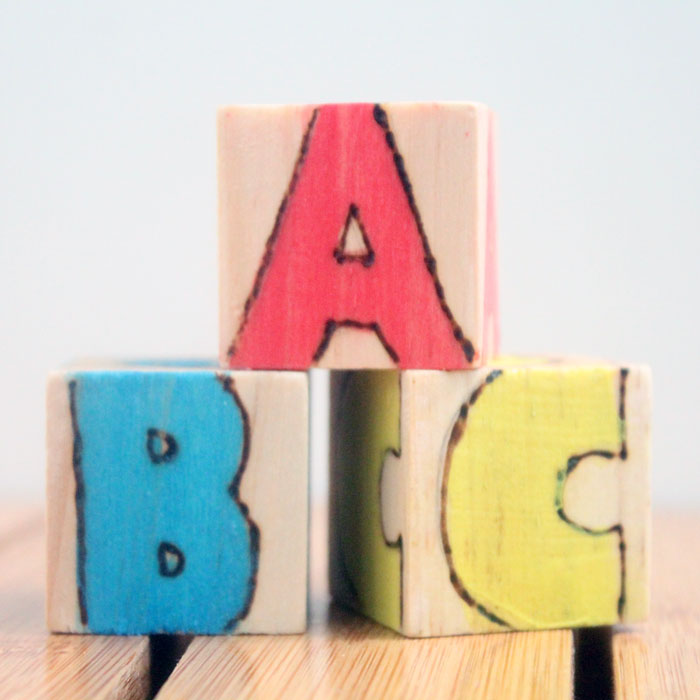 These colorful wooden alphabet blocks are surprisingly easy to make! They are so much fun to receive as a DIY baby gift and inexpensive to put together.