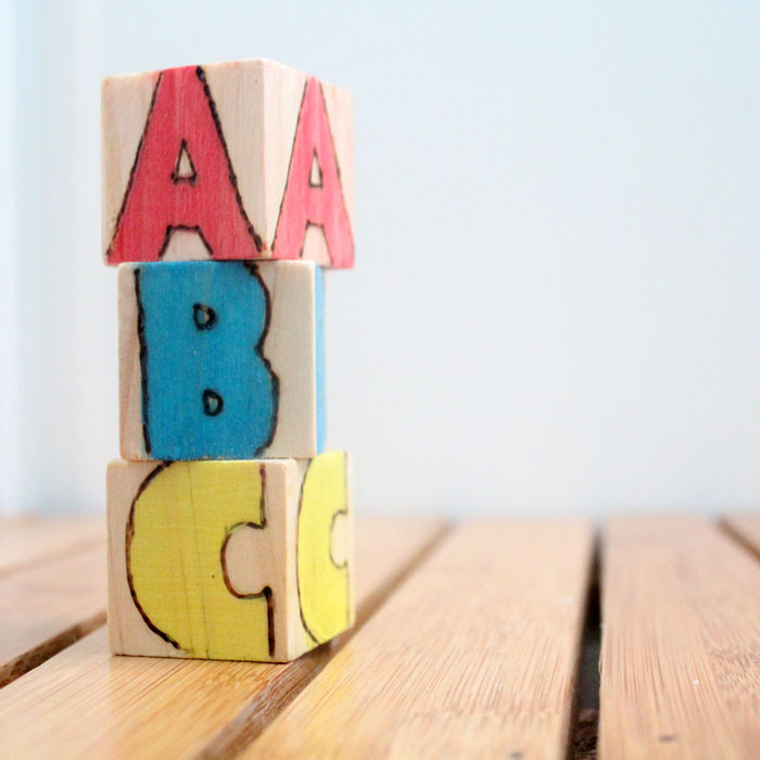 These colorful wooden alphabet blocks are surprisingly easy to make! They are so much fun to receive as a DIY baby gift and inexpensive to put together.