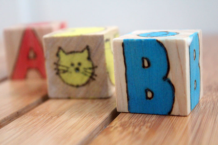 These colorful wooden alphabet blocks are surprisingly easy to make! They are so much fun to receive as a DIY baby gift and inexpensive to put together.