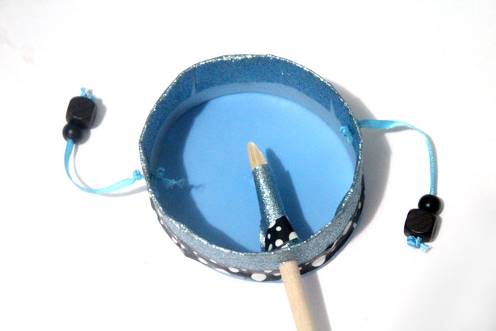 Make this fun diy musical instrument - a hand drum! Such a fun DIY toy for kids, and a craft that kids can help make, decorate, and play with afterward.