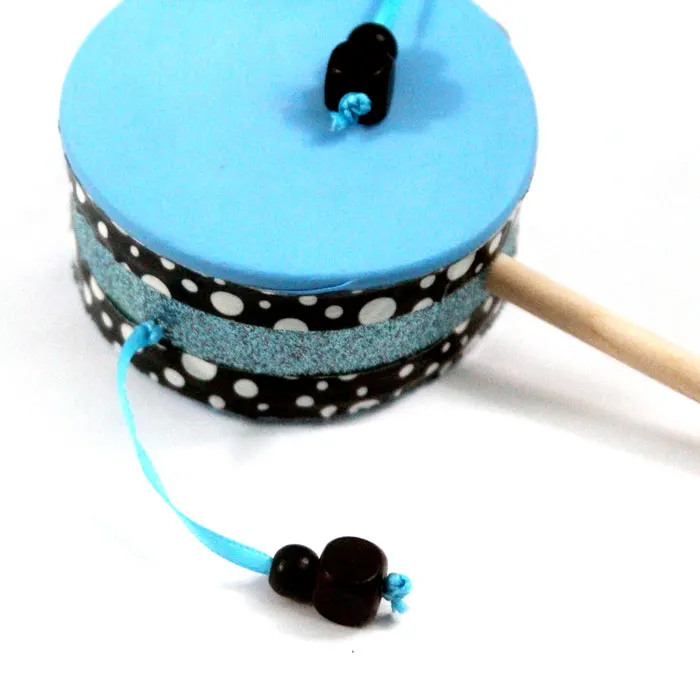 Make this fun diy musical instrument - a hand drum! Such a fun DIY toy for kids, and a craft that kids can help make, decorate, and play with afterward.