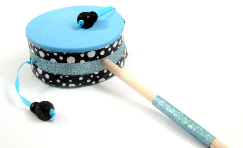 Make this fun diy musical instrument - a hand drum! Such a fun DIY toy for kids, and a craft that kids can help make, decorate, and play with afterward.