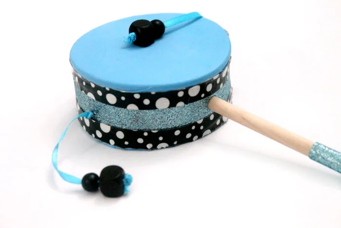 Make this fun diy musical instrument - a hand drum! Such a fun DIY toy for kids, and a craft that kids can help make, decorate, and play with afterward.