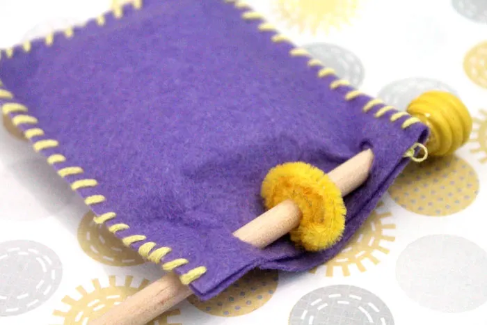 Make an adorable purim play set from felt! This DIY toy for the holiday of Purim includes hamantaschen, a megillah, a food package with "grape juice", and a gragger/noisemaker. It's an adorable DIY toy for toddlers and great for introducing the Jewish holidays to young kids.