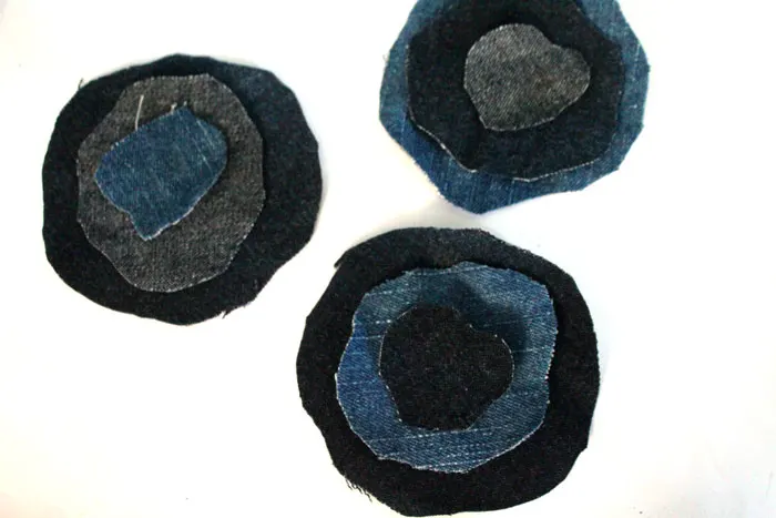 Make these super easy DIY recycled denim flowers. Perfect for making DIY accessories like headbands or hair clips, but I used it to update an old onesie. It's also a great way to upcycle and repurpose old jeans and a perfect craft for teens!