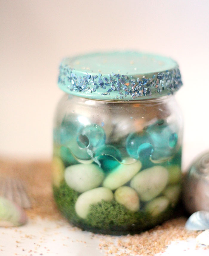 Have a favorite seashell? Make this beautiful beach-in-a-jar seashell keepsake craft to display! It's a great summer sea-inspired centerpiece, or just-for-fun idea for kids, adults, and teens!