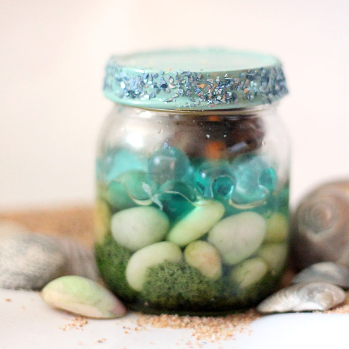 Have a favorite seashell? Make this beautiful beach-in-a-jar seashell keepsake craft to display! It's a great summer sea-inspired centerpiece, or just-for-fun idea for kids, adults, and teens!