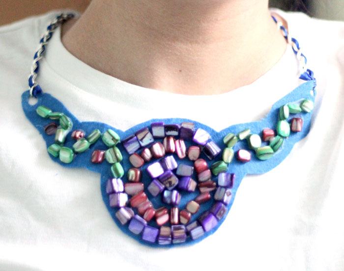 Make a beautiful DIY bib necklace with a pretty mosaic pattern. You can freeform or use symmetrical patterns on this fun jewelry making craft that's perfect for Spring, or any time you want to dress up a plain tee. It's so easy!