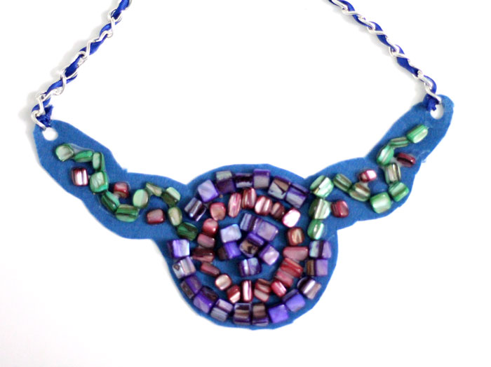 Make a beautiful DIY bib necklace with a pretty mosaic pattern. You can freeform or use symmetrical patterns on this fun jewelry making craft that's perfect for Spring, or any time you want to dress up a plain tee. It's so easy!