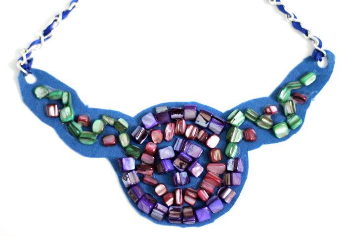 Make a beautiful DIY bib necklace with a pretty mosaic pattern. You can freeform or use symmetrical patterns on this fun jewelry making craft that's perfect for Spring, or any time you want to dress up a plain tee. It's so easy!