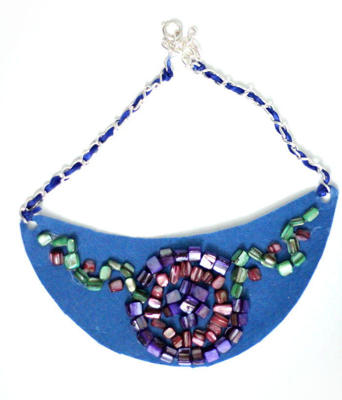 Make a beautiful DIY bib necklace with a pretty mosaic pattern. You can freeform or use symmetrical patterns on this fun jewelry making craft that's perfect for Spring, or any time you want to dress up a plain tee. It's so easy!