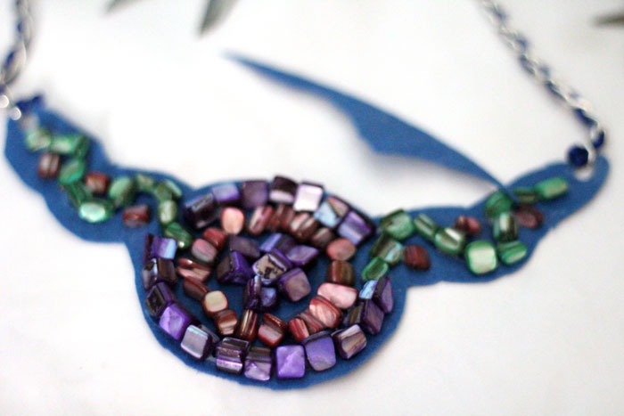 Make a beautiful DIY bib necklace with a pretty mosaic pattern. You can freeform or use symmetrical patterns on this fun jewelry making craft that's perfect for Spring, or any time you want to dress up a plain tee. It's so easy!