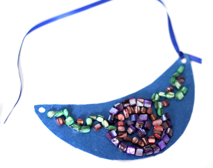 Make a beautiful DIY bib necklace with a pretty mosaic pattern. You can freeform or use symmetrical patterns on this fun jewelry making craft that's perfect for Spring, or any time you want to dress up a plain tee. It's so easy!