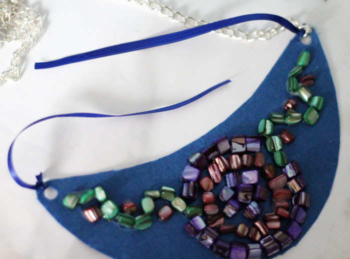 Make a beautiful DIY bib necklace with a pretty mosaic pattern. You can freeform or use symmetrical patterns on this fun jewelry making craft that's perfect for Spring, or any time you want to dress up a plain tee. It's so easy!