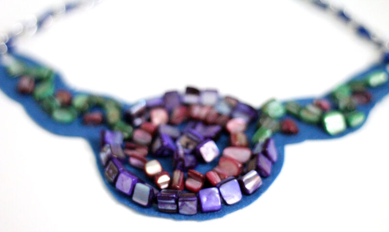 Make a beautiful DIY bib necklace with a pretty mosaic pattern. You can freeform or use symmetrical patterns on this fun jewelry making craft that's perfect for Spring, or any time you want to dress up a plain tee. It's so easy!