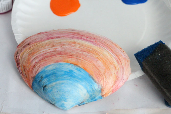 Make a beautiful painted seashell craft that totally fits! The stunning sunset beach scene is so appropriate for shells and makes a great art class prompt too - perfect for some summer fun!