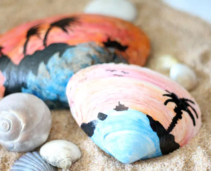 Make a beautiful painted seashell craft that totally fits! The stunning sunset beach scene is so appropriate for shells and makes a great art class prompt too - perfect for some summer fun!