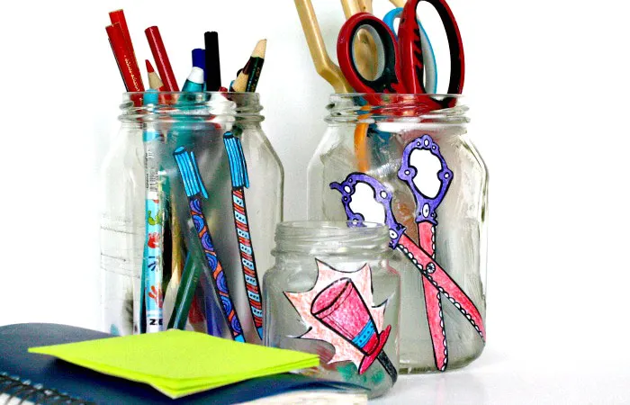 Um, why did I NOT think of this sooner? Check out how my friend took free printable adult coloring page and turned them into cool desk jar organizers, using recycled jars, and costing her literally pennies! This is one of my favorite easy and frugal desk organization ideas!