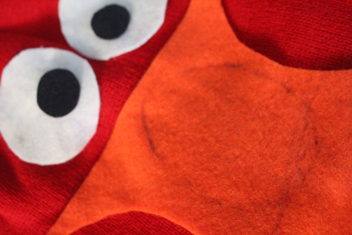 I made this easy DIY Elmo costume for my toddler in minutes! It's a simple, frugal, easy costume idea for toddlers or preschoolers who love Sesame Street and is a no-sew solution for moms who need to do things quickly. Perfect for Halloween or Purim.