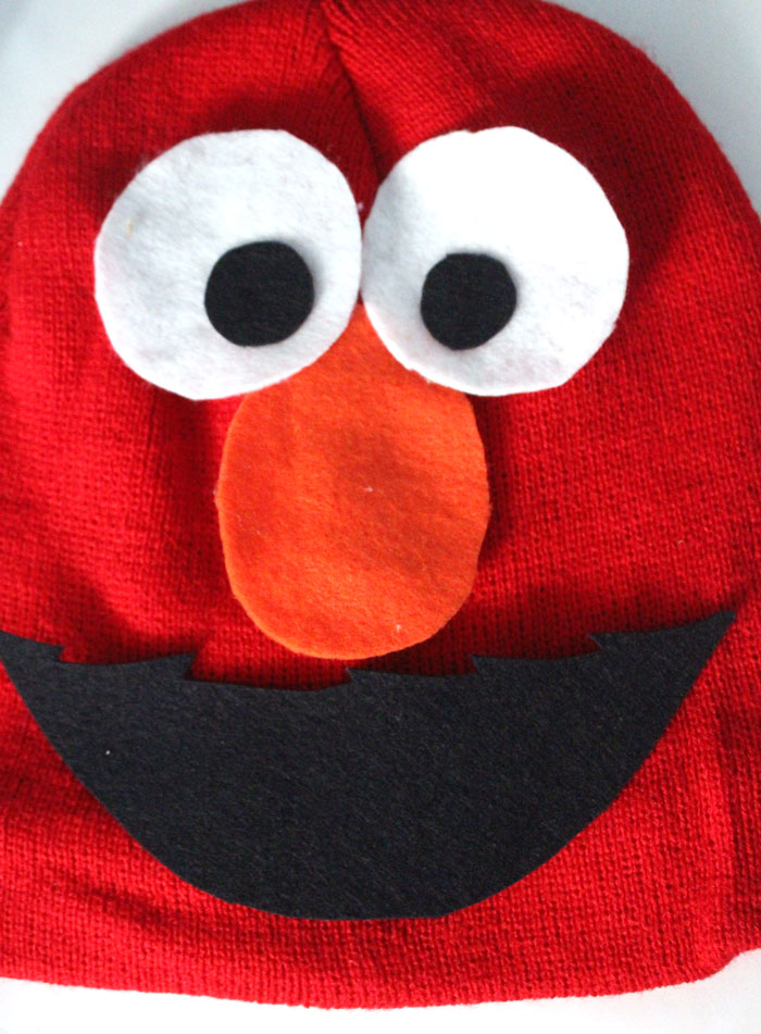 I made this easy DIY Elmo costume for my toddler in minutes! It's a simple, frugal, easy costume idea for toddlers or preschoolers who love Sesame Street and is a no-sew solution for moms who need to do things quickly. Perfect for Halloween or Purim.