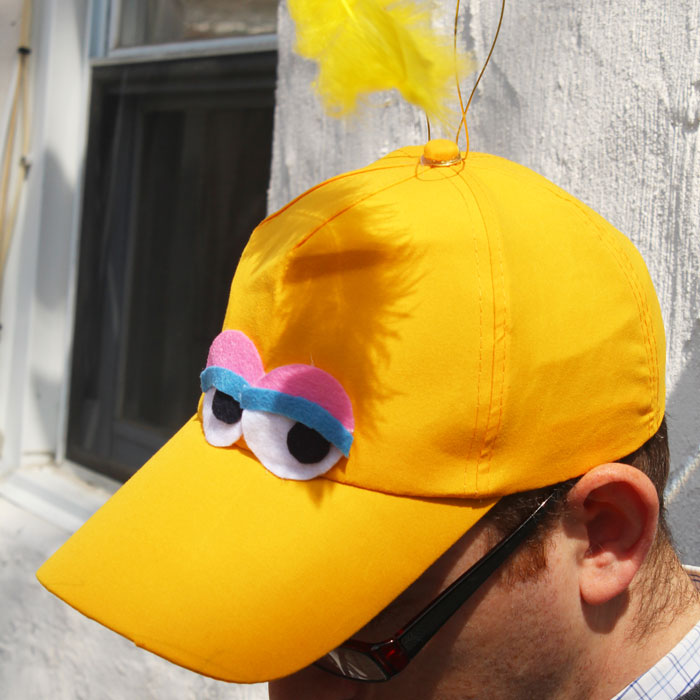 Make an easy no-sew DIY big bird costume hat! You can wear it alone or with a bigger getup, but this definitely speaks sesame street! Perfect for toddlers or adults for halloween, purim, or pretend play.