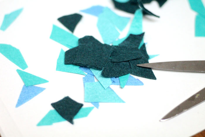 Make these beautiful DIY felt mosaic votive holders using up your felt scraps that you really should have thrown out. It's a perfect craft idea for your holiday table, to add art to your home via candles, or for any day!