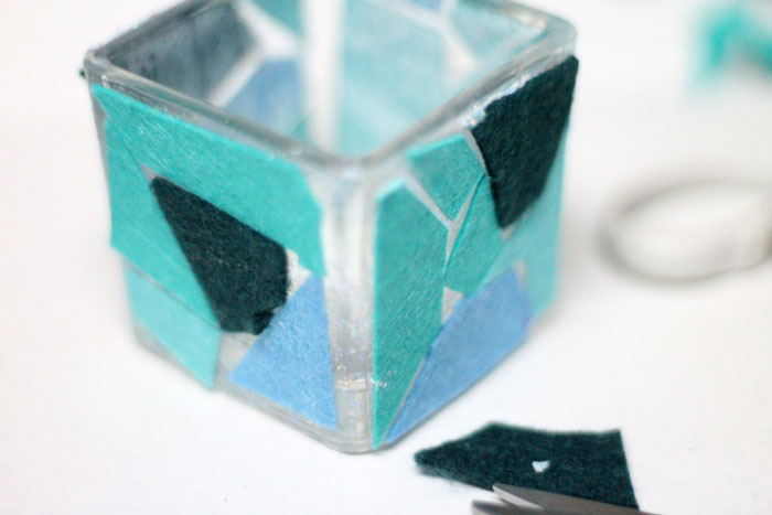 Make these beautiful DIY felt mosaic votive holders using up your felt scraps that you really should have thrown out. It's a perfect craft idea for your holiday table, to add art to your home via candles, or for any day!