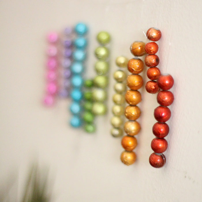 This beautiful DIY garland seems to disappear on the wall, leaving you with the hanging beaded strands! Such a cool effect. Make this easy beaded rainbow garland as a regular home decor staple or as a cool sukkah decoration craft.