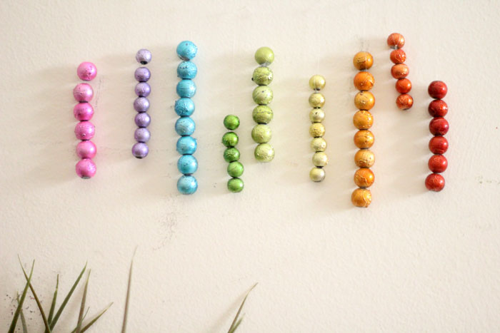 This beautiful DIY garland seems to disappear on the wall, leaving you with the hanging beaded strands! Such a cool effect. Make this easy beaded rainbow garland as a regular home decor staple or as a cool sukkah decoration craft.