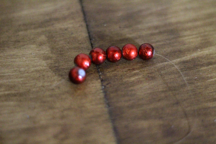 This beautiful DIY garland seems to disappear on the wall, leaving you with the hanging beaded strands! Such a cool effect. Make this easy beaded rainbow garland as a regular home decor staple or as a cool sukkah decoration craft.