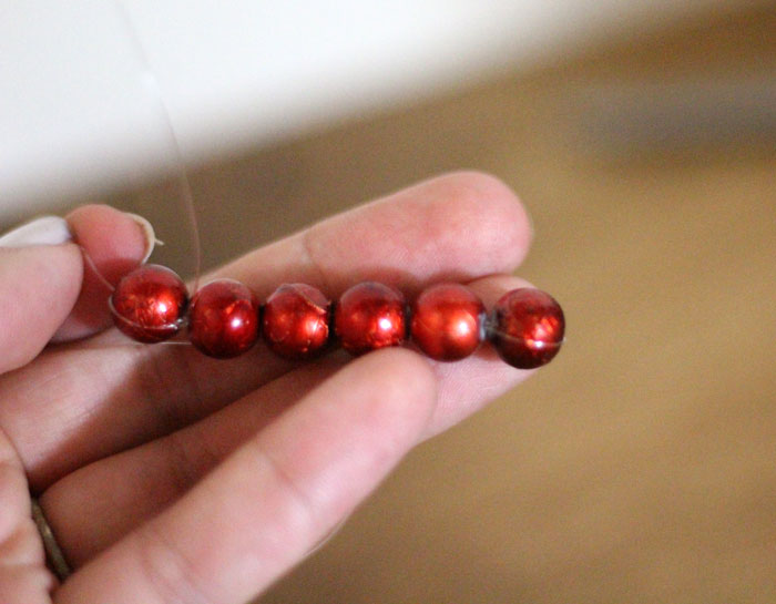 This beautiful DIY garland seems to disappear on the wall, leaving you with the hanging beaded strands! Such a cool effect. Make this easy beaded rainbow garland as a regular home decor staple or as a cool sukkah decoration craft.