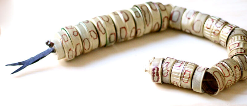 turn your recycling bin into a fun toy! Make a bottle cap rattlesnake craft for your little ones to play with - it actually rattles! This upcycled craft is a fun way to use up your bottle caps and a cute DIY toy idea.