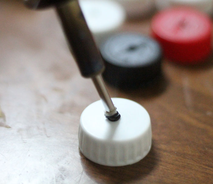 turn your recycling bin into a fun toy! Make a bottle cap rattlesnake craft for your little ones to play with - it actually rattles! This upcycled craft is a fun way to use up your bottle caps and a cute DIY toy idea.