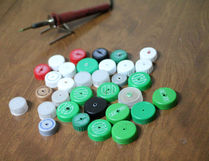 turn your recycling bin into a fun toy! Make a bottle cap rattlesnake craft for your little ones to play with - it actually rattles! This upcycled craft is a fun way to use up your bottle caps and a cute DIY toy idea.