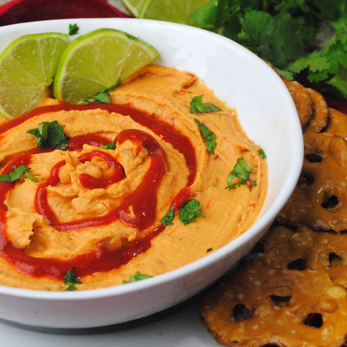 Make this delicious sriracha lime hummus recipe - a dip recipe with a kick! It's totally kid friendly and beautiful to display.