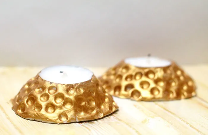 These beautiful faux hammered metal candle holders are stunning - and so easy to make! You don't need to be a pro to give this easy craft and DIY gift idea a whirl. Make DIY clay candle holders using a very specific clay that will work for this craft idea.