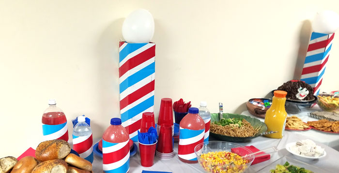 Make this barber shop pole centerpiece for you haircut party! This cool barber shop party decor idea is easy to make, mess-free, and uses recycled materials and is a great, easy upcycled cardboard box craft idea!