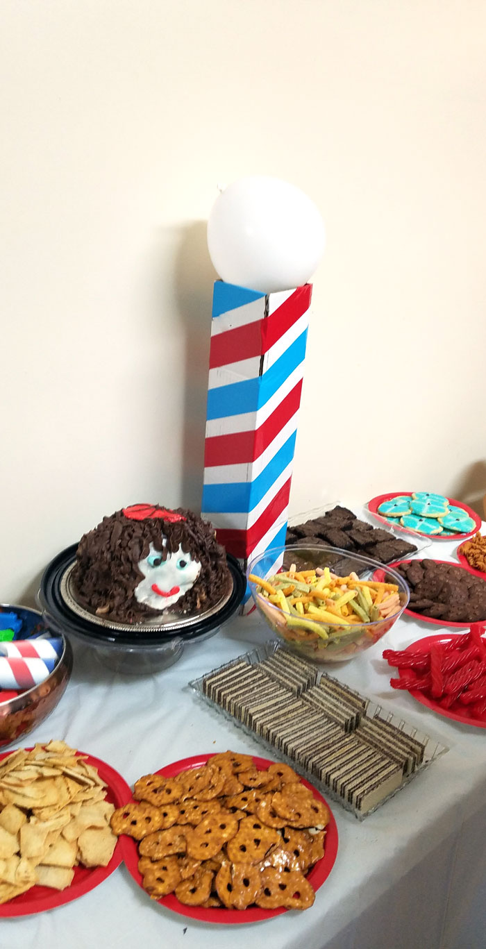 Make this barber shop pole centerpiece for you haircut party! This cool barber shop party decor idea is easy to make, mess-free, and uses recycled materials and is a great, easy upcycled cardboard box craft idea!